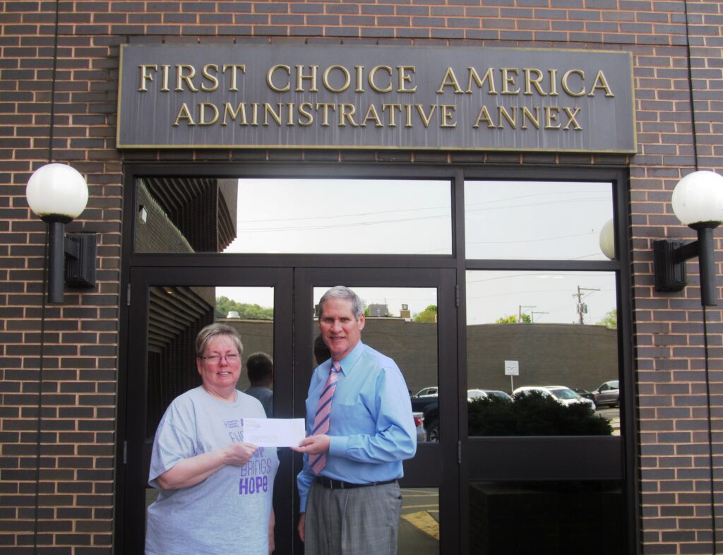 April Kimble accepting a check from Scott WInwood