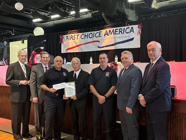 First Choice America board of directors giving award to Steubenville Firefighters